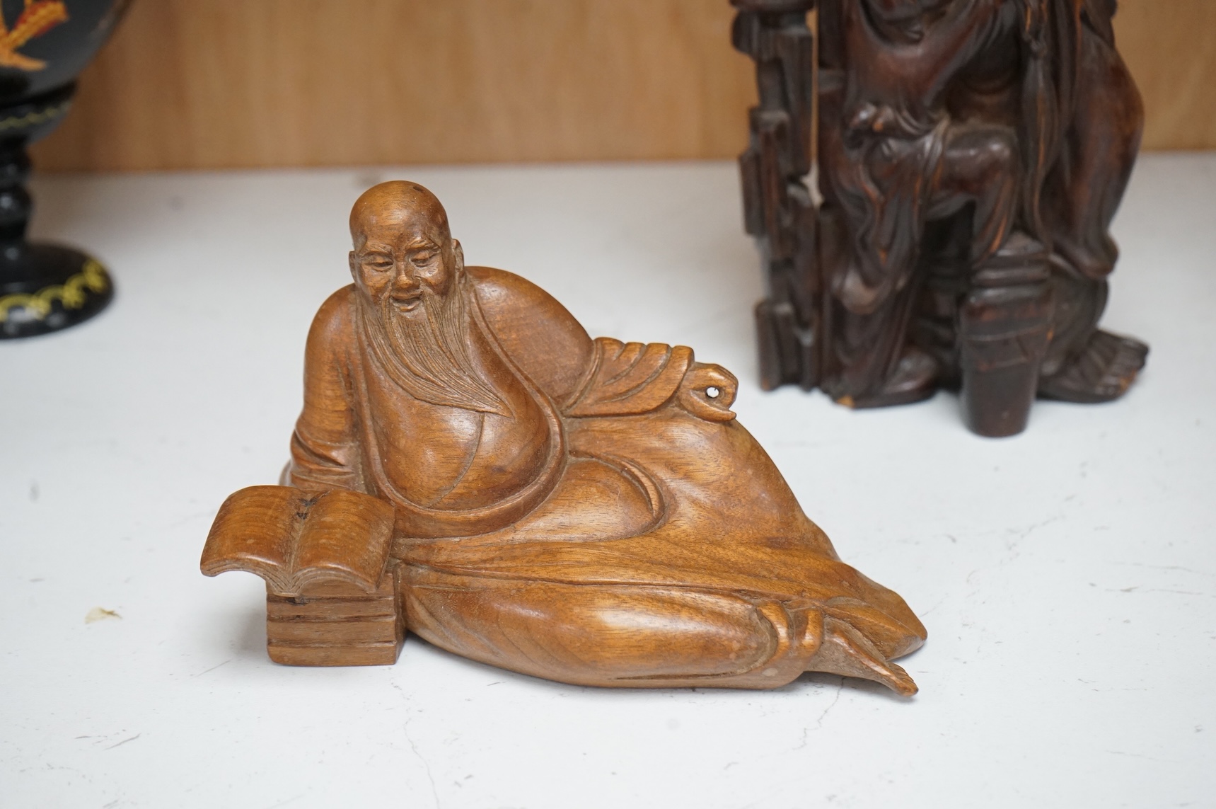 A Chinese root carving of a luohan and another of a reclining monk, largest 26cm high (2)